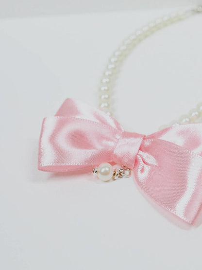 Collarino di perle con fiocco rosa