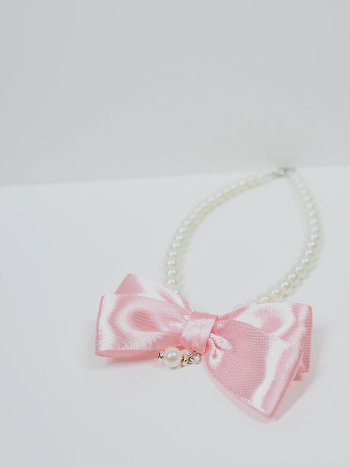 Collarino di perle con fiocco rosa